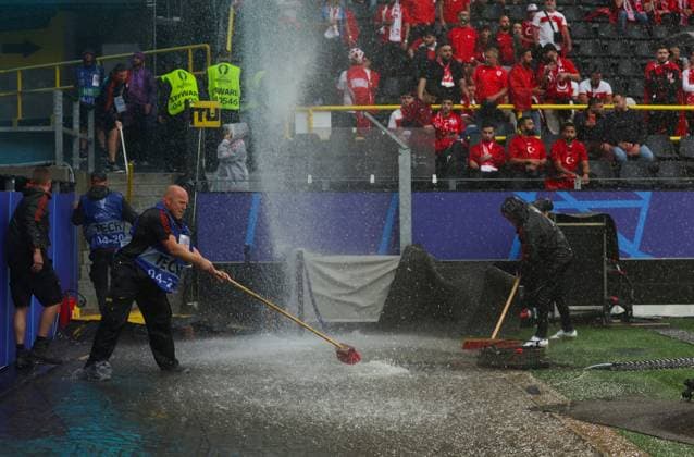 Groundstaff sweep away a flooded area after heavy rain Turkiye v Georgia, UEFA European Championship, EM, Europameisterschaft 2024, Group F, Football, BVB Stadion, Dortmund, Germany, 18 Jun 2024 EDITORIAL USE ONLY No use with unauthorised audio, video, data, fixture lists, club league logos or live services. Online in-match use limited to 120 images, no video emulation. No use in betting, games or single club league player publications. Copyright: xPaulxCurrie Shutterstockx 14543470ai