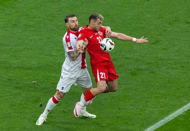 Football - UEFA EURO, EM, Europameisterschaft,Fussball 2024 - Group F - Turkey v Georgia DORTMUND, GERMANY - Tuesday, June 18, 2024: Turkey s BarÄ±Åü Alper YÄ±lmaz (R) is challenged by Georgia s captain Guram Kashia during the UEFA Euro 2024 Group F match between Turkey and Georgia at the Westfalenstadion. (Photo by David Rawcliffe Propaganda) DORTMUND Westfalenstadion NORTH RHINE-WESTPHALIA GERMANY  Copyright: xDavidxRawcliffex P2024-06-18-Turkey_Georgia-10