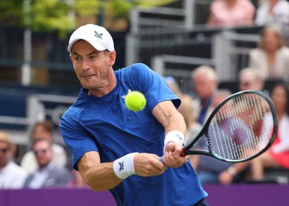 18th June 2024; Cinch Championships, Queens Club, West Kensington, London, England: Cinch Championships Queens Club, Day 2; Spectators waving the flag of Scotland for Andy Murray (GBR) with a backhand shot to Alexei Papyrin (AUS), mens singles match  ActionPlus12656465 JohnxPatrickxFletcher