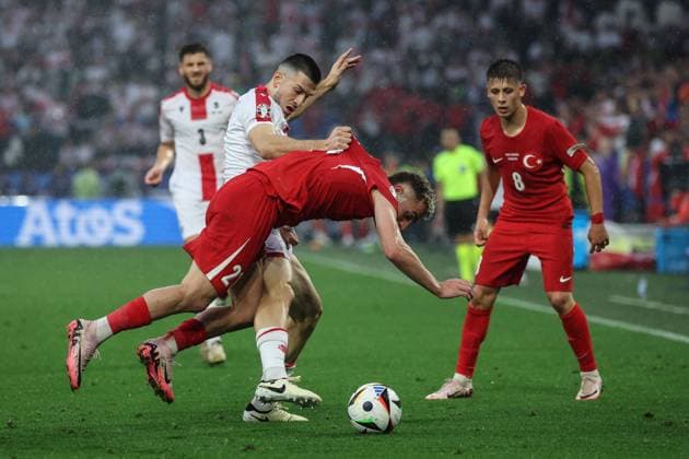 (240619) -- DORTMUND, June 19, 2024 -- Baris Alper Yilmaz (2nd R) of Turkiye vies with Luka Lochoshvili (2nd L) of Georgia during the UEFA EURO, EM, Europameisterschaft,Fussball 2024 Group F match between Turkiye and Georgia in Dortmund, Germany on June 18, 2024. ) (SP)GERMANY-DORTMUND-FOOTBALL-EURO 2024-T?RKIYE VS GEORGIA PanxYulong 