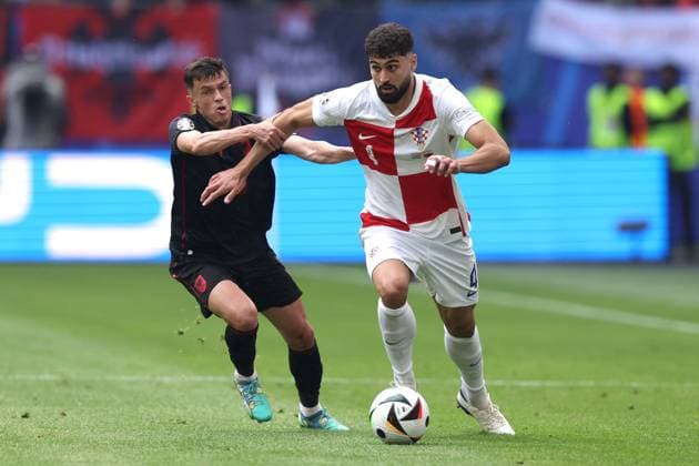 Jasir Asani of Albania and Josko Gvardiol of Croatia Croatia v Albania, UEFA European Championship, EM, Europameisterschaft 2024, Group B, Football, Volksparkstadion, Hamburg, Germany, 19 Jun 2024 EDITORIAL USE ONLY No use with unauthorised audio, video, data, fixture lists, club league logos or live services. Online in-match use limited to 120 images, no video emulation. No use in betting, games or single club league player publications.  Copyright: xPaulxCurrie Shutterstockx 14543648am