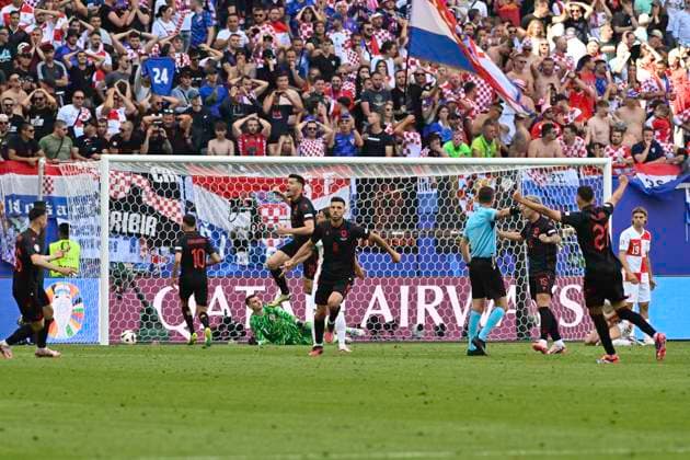 GER, Euro 2024, Group B, Croatia HRV vs Albania ALB 19 06 2024, Volksparkstadion, GER, Euro 2024, Group B, Croatia HRV vs Albania ALB in picture Klaus Gjasula ALB 08 shoots the goal to 2 2 for Albania past goalkeeper Dominik Livakovic HRV 01 and cheers with the team nordphotoxGmbH xWitke nph00002