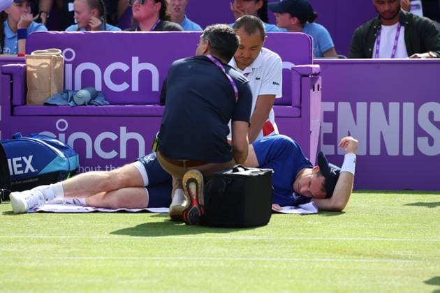 19th June 2024; Cinch Championships, Queens Club, West Kensington, London, England: Cinch Championships Queens Club, Day 3; Andy Murray (GBR) receiving medical treatment from the doctor on Centre Court before forcing to retire due to injury in the first set against Jordan Thompson (AUS), mens singles match  ActionPlus12656888 JohnxPatrickxFletcher