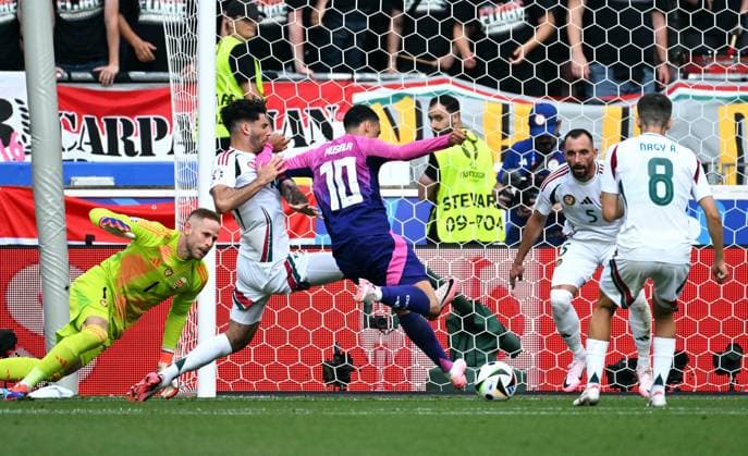 Football, European Championship, EURO 2024, Group A, MHP Arena Stuttgart Germany Hungary Jamal Musiala GER scores the goal to make it 1-0 against Dominik Szoboszlai HUN and Peter Gulacsi HUN Action
