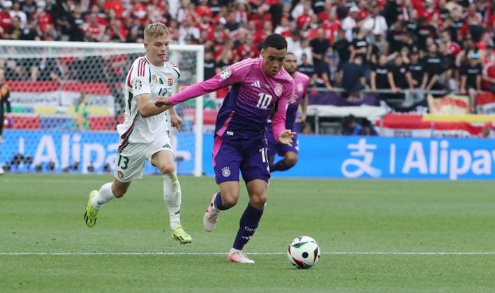 Andras Schäfer , Jamal Musiala duel match scene Action Sport Football Soccer European Championship Euro 2024 European Championship Men Season 2023 2024 19 06 2024 Germany GER vs Hungary HUN in Stuttgart DFL regulations prohibit any use of photographs as image sequences and or quasi video