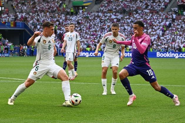 19 06 2024, xsltx, Football EM 2024, Germany Hungary emspor, v l Willi Orban Hungary, 6 , Adam Nagy Hungary, 8 , Jamal Musiala Germany, 10 duel, fight, tackle DFL DFB REGULATIONS PROHIBIT ANY USE OF PHOTOGRAPHS as IMAGE SEQUENCES and or QUASI VIDEO Stuttgart