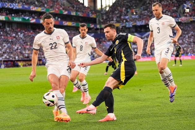 Scotland s Andrew Robertson fights for the ball with Switzerland s Fabian Schar during the Euro 2024 soccer match between Scotland and Swiss at the RheinEnergie Stadion, Cologne, Germany - Wednesday 19 , June , 2024. - Soccer .  Copyright: xFabioxFerrari LaPressex