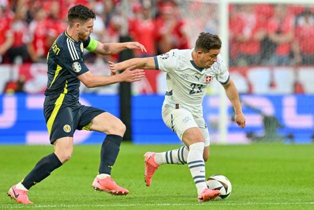 240619 EURO2024 SCOTLAND VS SWITZERLAND Andrew Robertson (3) of Scotland fighting for the ball with Xherdan Shaqiri (23) of Switzerland during a soccer game between the national teams of Scotland and Switzerland on the 2nd matchday in Group A in the group stage of the UEFA EURO, EM, Europameisterschaft,Fussball 2024 tournament , on Wednesday 19 June 2024 in Cologne , Germany . PHOTO SPORTPIX David Catry Cologne GERMANY  Copyright: xx 465068