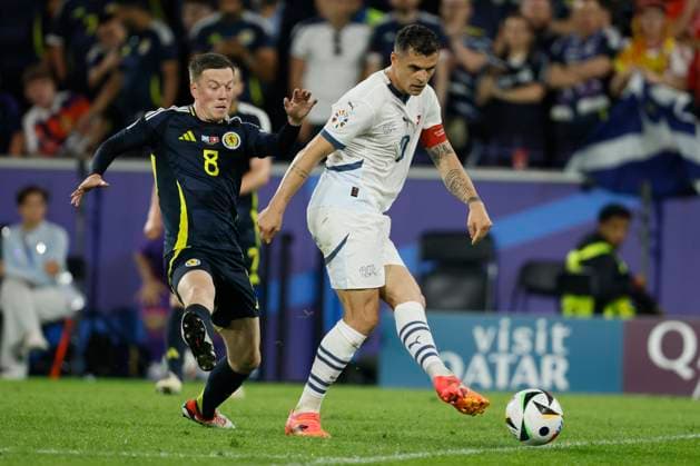 Scotland v Switzerland: Group A - UEFA EURO, EM, Europameisterschaft,Fussball 2024 Callum McGregor of Scotland and Granit Xhaka of Switzerland challenge during the UEFA EURO 2024 group stage match between Scotland and Switzerland at Cologne Stadium on June 19, 2024 in Cologne, Germany. Cologne Cologne Stadium Germany Germany Copyright: xRichardxSellers Sportsphoto APLx 14041525