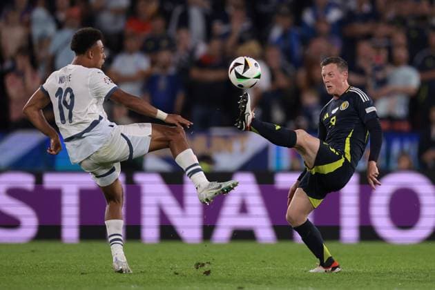 Cologne, Germany, 19th June 2024. Dan Ndoye of Switzerland challenges Callum McGregor of Scotland during the UEFA European Championships match at Cologne Stadium, Cologne. Picture credit should read: Jonathan Moscrop Sportimage EDITORIAL USE ONLY. No use with unauthorised audio, video, data, fixture lists, club league logos or live services. Online in-match use limited to 120 images, no video emulation. No use in betting, games or single club league player publications. SPI-3186-0023