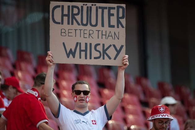 Swiss fan with poster Chrueueter Chrüüter better than Whisky, general, feature, border motif, symbol photo group phase group A Scotland SCO Switzerland SUI 1 1 on 19 06 2024 Stadion Koeln, Cologne Stadium, Football UEFA EURO 2024 GERMANY from 14 06 2024 14 07 2024 Â