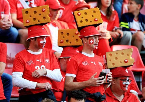 Switzerland fans wearing cheese hats Scotland v Switzerland, UEFA European Championship, EM, Europameisterschaft 2024, Group A, Football, Cologne Stadium, Cologne, Germany, 19 Jun 2024 EDITORIAL USE ONLY No use with unauthorised audio, video, data, fixture lists, club league logos or live services. Online in-match use limited to 120 images, no video emulation. No use in betting, games or single club league player publications. Copyright: xMattxWest Shutterstockx 14543656fi