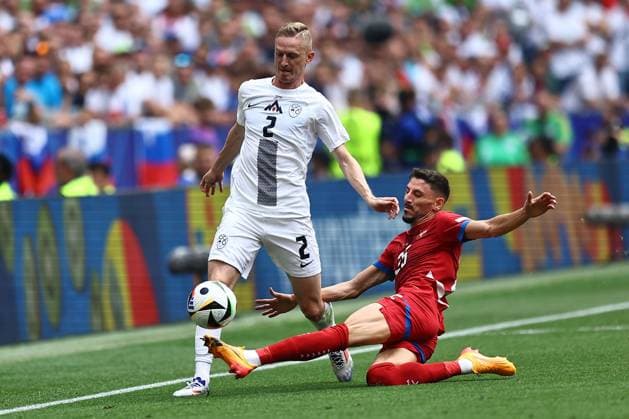 Zan Karnicnik of Slovenia is fouled by Filip Mladenovic of Serbia Slovenia v Serbia, UEFA European Championship, EM, Europameisterschaft 2024, Group C, Football, Munich Football Arena, Munich, Germany, 20 Jun 2024 EDITORIAL USE ONLY No use with unauthorised audio, video, data, fixture lists, club league logos or live services. Online in-match use limited to 120 images, no video emulation. No use in betting, games or single club league player publications. Copyright: xMichaelxZemanek Shutterstockx 14543659ar