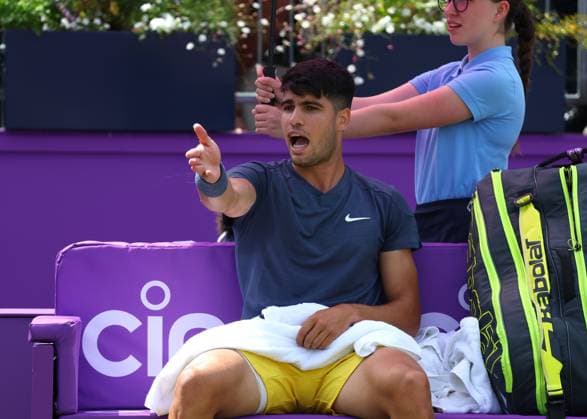 20th June 2024; Cinch Championships, Queens Club, West Kensington, London, England: Cinch Championships Queens Club, Day 4; Carlos Alcaraz (ESP) complaining to Umpire Mohamed Lahyani (SWE) about the ball kids on Centre Court during a break in the first set against Jack Draper (GBR), mens singles match  ActionPlus12657204 JohnxPatrickxFletcher