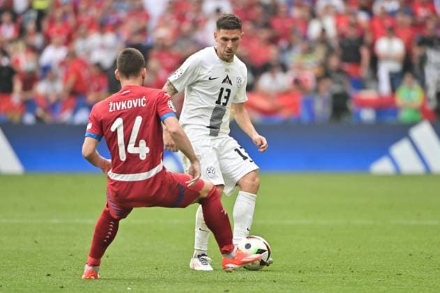 Picture shows Andrija Zivkovic 14, Serbia , Erik Janza 13, Slovenia with ball on foot, 20 06 2024, Munich, Soccer, European Championship, Slovenia Serbia, EVENT REGULATIONS PROHIBIT ANY USE OF PHOTOGRAPHS AS IMAGE SEQUENCES AND OR QUASI VIDEO xklx