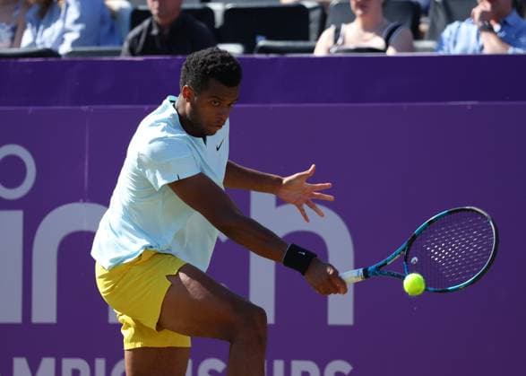 20th June 2024; Cinch Championships, Queens Club, West Kensington, London, England: Cinch Championships Queens Club, Day 4; Mpetshi Perricard (FRA) with a backhand shot to Billy Harris (GBR), mens singles match  ActionPlus12657396 JohnxPatrickxFletcher
