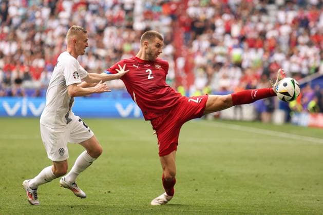 Slovenia Vs Serbia in Munich, Germany - 20 Jun 2024 Strahinja Pavlovic (R) of Serbia and Zan Karnicnik (L) of Slovenia seen in action during the UEFA EURO, EM, Europameisterschaft,Fussball 2024 group stage match between Slovenia and Serbia at Munich Football Arena. (Final score; Slovenia 1:1 Serbia) Munich Germany Copyright: xSergeixMikhailichenkox xSOPAxImagesx 13Mikhailichenko_Slo-Ser
