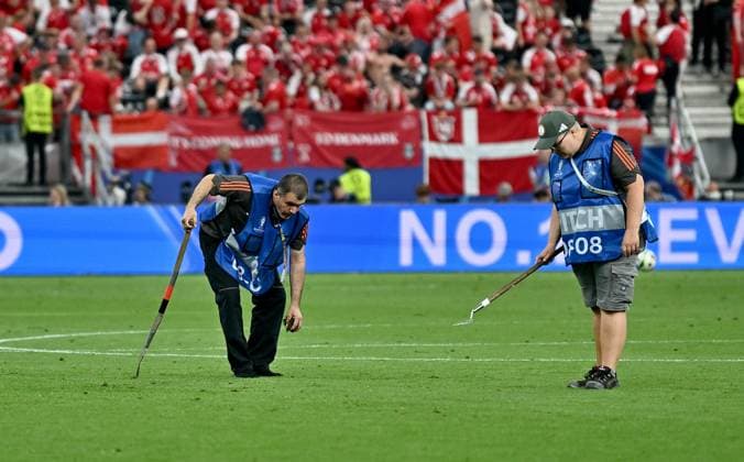 20 06 2024, xscotx, European Football Championship 2024, Denmark England, emspor, v l Greenkeeper groundskeeper tending the broken turf in the Frankfurt Arena Deutsche Bank Park Hole Playing field Lawn parts Lawn pieces Lawn pieces Earth Field Field Green Green destroyed destroyed Broken hole Holes Holes Frankfurt am Main