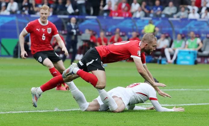Konrad Laimer in a duel with Piotr Zielinski Sport Football Soccer European Championship Euro 2024 European Championship Men Season 2023 2024 21 06 2024 Poland POL vs Austria AUT in Berlin DFL regulations prohibit any use of photographs as image sequences and or quasi video