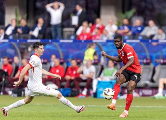 21st June 2024; Olympiastadion, Berlin, Germany; Euro 2024 Group D Football, Poland versus Austria; Robert Lewandowski (POL) cannot stop the shot from Kevin Danso (AUT)  ActionPlus12658327 FotoxOlimpik