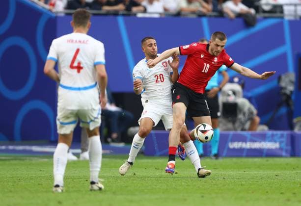 Giorgi Chakvetadze of Georgia is challenged by Ondrej Lingr of Czech Republic Georgia v Czechia, UEFA European Championship, EM, Europameisterschaft 2024, Group F, Football, Volksparkstadion, Hamburg, Germany, 22 Jun 2024 EDITORIAL USE ONLY No use with unauthorised audio, video, data, fixture lists, club league logos or live services. Online in-match use limited to 120 images, no video emulation. No use in betting, games or single club league player publications.  Copyright: xKieranxMcManus Shutterstockx 14548025cf