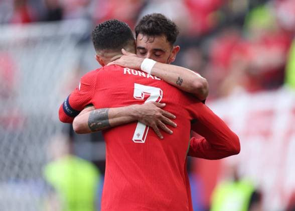 Dortmund, Germany, 22nd June 2024. Scorer Bruno Fernandes of Portugal hugs the provider Cristiano Ronaldo of Portugal for their third goal during the UEFA European Championships match at BVB Stadion, Dortmund. Picture credit should read: David Klein Sportimage EDITORIAL USE ONLY. No use with unauthorised audio, video, data, fixture lists, club league logos or live services. Online in-match use limited to 120 images, no video emulation. No use in betting, games or single club league player publications. SPI-3202-0070