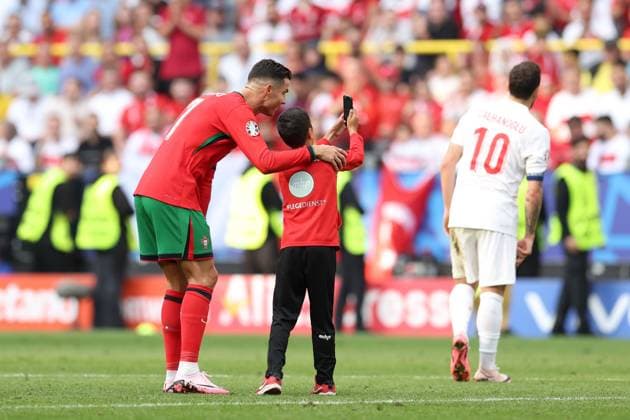 A young fan takes a selfie with Cristiano Ronaldo of Portugal during the match Turkiye v Portugal, UEFA European Championship, EM, Europameisterschaft 2024, Group F, Football, BVB Stadion, Dortmund, Germany, 22 Jun 2024 EDITORIAL USE ONLY No use with unauthorised audio, video, data, fixture lists, club league logos or live services. Online in-match use limited to 120 images, no video emulation. No use in betting, games or single club league player publications.  Copyright: xPaulxCurrie Shutterstockx 14548034el