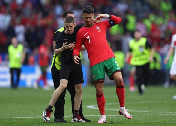 Dortmund, Germany, 22nd June 2024. A second fan runs onto the pitch to try and take selfie with Cristiano Ronaldo of Portugal during the UEFA European Championships match at BVB Stadion, Dortmund. Picture credit should read: David Klein Sportimage EDITORIAL USE ONLY. No use with unauthorised audio, video, data, fixture lists, club league logos or live services. Online in-match use limited to 120 images, no video emulation. No use in betting, games or single club league player publications. SPI-3202-0104