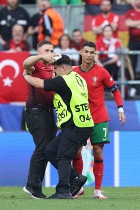 A Turkey fan attempts to take a selfie with Cristiano Ronaldo of Portugal during the match Turkiye v Portugal, UEFA European Championship, EM, Europameisterschaft 2024, Group F, Football, BVB Stadion, Dortmund, Germany, 22 Jun 2024 EDITORIAL USE ONLY No use with unauthorised audio, video, data, fixture lists, club league logos or live services. Online in-match use limited to 120 images, no video emulation. No use in betting, games or single club league player publications. Copyright: xPaulxCurrie Shutterstockx 14548034fa
