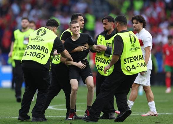 Dortmund, Germany, 22nd June 2024. A second fan runs onto the pitch to try and take selfie with Cristiano Ronaldo of Portugal during the UEFA European Championships match at BVB Stadion, Dortmund. Picture credit should read: David Klein Sportimage EDITORIAL USE ONLY. No use with unauthorised audio, video, data, fixture lists, club league logos or live services. Online in-match use limited to 120 images, no video emulation. No use in betting, games or single club league player publications. SPI-3202-0106
