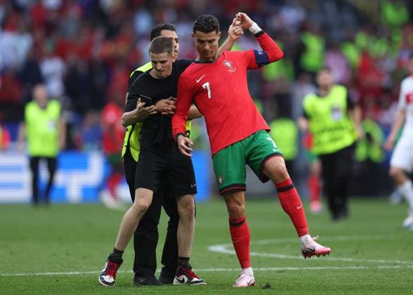 Dortmund, Germany, 22nd June 2024. A second fan runs onto the pitch to try and take selfie with Cristiano Ronaldo of Portugal during the UEFA European Championships match at BVB Stadion, Dortmund. Picture credit should read: David Klein Sportimage EDITORIAL USE ONLY. No use with unauthorised audio, video, data, fixture lists, club league logos or live services. Online in-match use limited to 120 images, no video emulation. No use in betting, games or single club league player publications. SPI-3202-0109