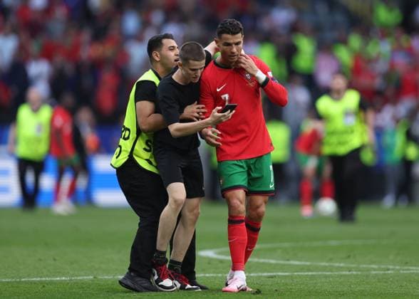 Dortmund, Germany, 22nd June 2024. A second fan runs onto the pitch to try and take selfie with Cristiano Ronaldo of Portugal during the UEFA European Championships match at BVB Stadion, Dortmund. Picture credit should read: David Klein Sportimage EDITORIAL USE ONLY. No use with unauthorised audio, video, data, fixture lists, club league logos or live services. Online in-match use limited to 120 images, no video emulation. No use in betting, games or single club league player publications. SPI-3202-0111