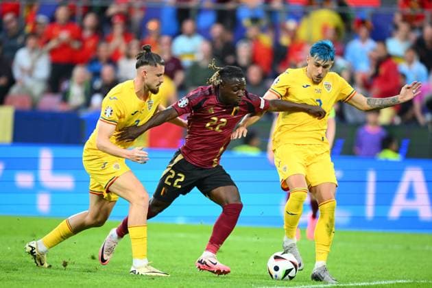 Belgium v Romania Group E - UEFA EURO, EM, Europameisterschaft,Fussball 2024 COLOGNE, GERMANY - JUNE 22 : Doku Jeremy forward of Belgium is challenged by Radu Dragusin defender of Romania and Andrei Ratiu defender of Romania during the UEFA EURO 2024 European Football Championship tournament group E stage match between Belgium and Romania at Cologne Stadium on June 22, 2024 in Cologne, Germany, 22 06 2024 Cologne Germany  Copyright: xVincentxKalutx
