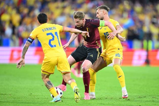 Belgium v Romania Group E - UEFA EURO, EM, Europameisterschaft,Fussball 2024 COLOGNE, GERMANY - JUNE 22 : De Bruyne Kevin forward of Belgium is challenged by Denis Dragus forward of Romania and Nicolae Stanciu midfielder of Romania during the UEFA EURO 2024 European Football Championship tournament group E stage match between Belgium and Romania at Cologne Stadium on June 22, 2024 in Cologne, Germany, 22 06 2024 Cologne Germany  Copyright: xVincentxKalutx