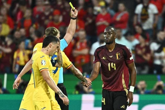 240622 EURO2024 BELGIUM VS ROMANIA Dodi Lukebakio (14) of Belgium receives a yellow card from referee Szymon Marciniak during a soccer game between the national teams of Belgium, called the Red Devils and Romania on the second matchday in Group E in the group stage of the UEFA EURO, EM, Europameisterschaft,Fussball 2024 tournament , on Saturday 22 June 2024 in Cologne , Germany . PHOTO Isosport Maarten Straetemans Cologne GERMANY  Copyright: xx 466917