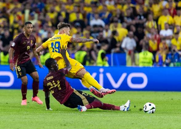 Koeln, RheinEnergieStadion, 22 06 2024 Amadou Onana of belgium challenges Denis Dragus of romania during the match UEFA European Championship 2024 Belgium v Romania