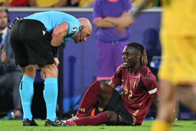 240622 EURO2024 BELGIUM VS ROMANIA referee Szymon Marciniak checks on Jeremy Doku (22) of Belgium laying down with an injury during a soccer game between the national teams of Belgium, called the Red Devils and Romania on the second matchday in Group E in the group stage of the UEFA EURO, EM, Europameisterschaft,Fussball 2024 tournament , on Saturday 22 June 2024 in Cologne , Germany . PHOTO SPORTPIX David Catry Cologne GERMANY  Copyright: xx 467019