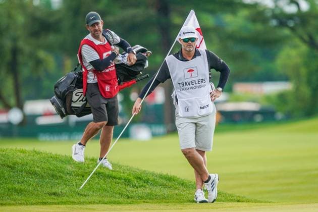 June 22, 2024, Cromwell, Connecticut, USA: Caddies Paul Tesori (L) and Jonathan Jakovac wait on the 9th green as their respective golfers, Tom Kim and Collin Morikawa line up a their putts on the 9th green during the third round of the 2024 Travelers Championship at TPC River Highlands. Cromwell USA - ZUMAw109 20240622_fap_w109_061 Copyright: xDebbyxWongx