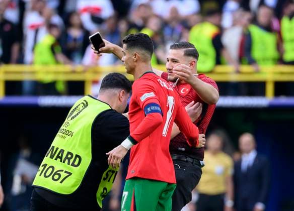a streaker on the pitch wants to take a selfie with Cristiano RONALDO POR, an orner carries him off Preliminary round 2 Matchday, Group F, Match M23, Turkey TUR Portugal POR 0 3, on 22 06 2024 in Dortmund Germany European Football Championship 2024 from 14 06 14 07 2024 in Germany Â
