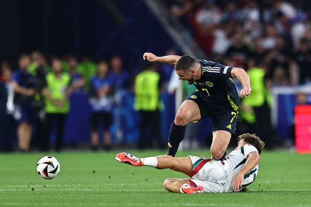 John McGinn of Scotland is fouled by Callum Styles of Hungary Scotland v Hungary, UEFA European Championship, EM, Europameisterschaft 2024, Group A, Football, Stuttgart Arena, Stuttgart, Germany, 23 Jun 2024 EDITORIAL USE ONLY No use with unauthorised audio, video, data, fixture lists, club league logos or live services. Online in-match use limited to 120 images, no video emulation. No use in betting, games or single club league player publications.  Copyright: xMichaelxZemanek Shutterstockx 14548075y