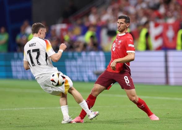 Frankfurt, Germany, 23rd June 2024. Remo Freuler of Switzerland tackled by Florian Wirtz of Germany during the UEFA European Championships match at Commerzbank-Arena, Frankfurt. Picture credit should read: David Klein Sportimage EDITORIAL USE ONLY. No use with unauthorised audio, video, data, fixture lists, club league logos or live services. Online in-match use limited to 120 images, no video emulation. No use in betting, games or single club league player publications. SPI-3203-0054