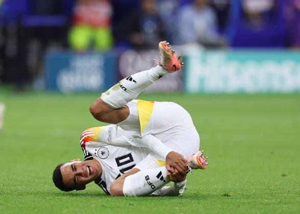 Frankfurt, Germany, 23rd June 2024. Jamal Musiala of Germany holds his ankle in pain during the UEFA European Championships match at Commerzbank-Arena, Frankfurt. Picture credit should read: David Klein Sportimage EDITORIAL USE ONLY. No use with unauthorised audio, video, data, fixture lists, club league logos or live services. Online in-match use limited to 120 images, no video emulation. No use in betting, games or single club league player publications. SPI-3203-0097