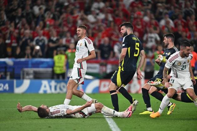 STUTTGART, GERMANY - JUNE 23: Barnabas Varga of Hungary lies on the ground after a collision with goalkeeper Angus Gunn of Scotland during the UEFA EURO, EM, Europameisterschaft,Fussball 2024 group stage match between Scotland and Hungary at Stuttgart Arena on June 23, 2024 in Stuttgart, G Scotland v Hungary: Group A - UEFA EURO 2024 Copyright: xSebastianxFrej MBxMediax