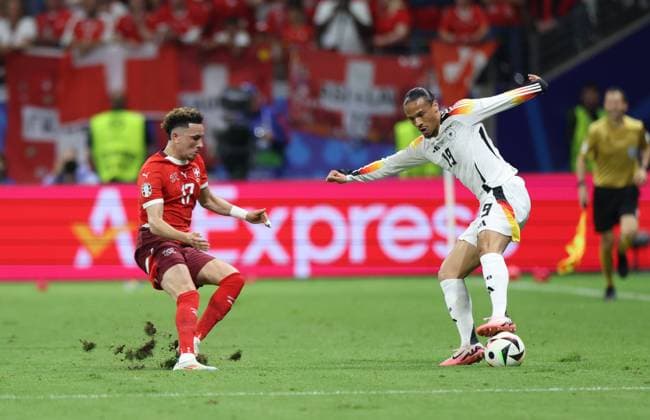 (240624) -- FRANKFURT, June 24, 2024 -- Leroy Sane (R) of Germany vies with Ruben Vargas of Switzerland during the UEFA EURO, EM, Europameisterschaft,Fussball 2024 Group A match between Germany and Switzerland in Frankfurt, Germany, June 23, 2024. ) (SP)GERMANY-FRANKFURT-FOOTBALL-EURO 2024-GERMANY VS SWITZERLAND BaixXuefei 