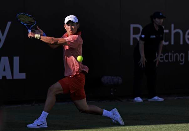 24th June 2024; Devonshire Park, Eastbourne, East Sussex, England: Rothesay International Eastbourne, Day 1; Juncheng Shang (CHN) plays a backhand against Tomas Martin Etchverry (ARG)  ActionPlus12660062 HongboxChen