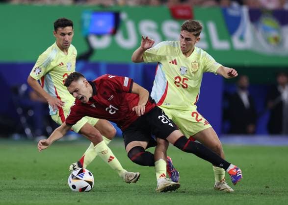 Dusseldorf, Germany, 24th June 2024. Kristjan Asllani of Albania tackled by Fermin Lopez of Spain during the UEFA European Championships match at Dusseldorf Arena, Dusseldorf. Picture credit should read: David Klein Sportimage EDITORIAL USE ONLY. No use with unauthorised audio, video, data, fixture lists, club league logos or live services. Online in-match use limited to 120 images, no video emulation. No use in betting, games or single club league player publications. SPI-3204-0093