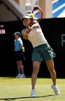 25th June 2024; Devonshire Park, Eastbourne, East Sussex, England: Rothesay International Eastbourne, Day 2, Yuriko Miyazaki (GBR) plays a backhand against Elise Mertens (BEL) womens singles  ActionPlus12660318 HongboxChen