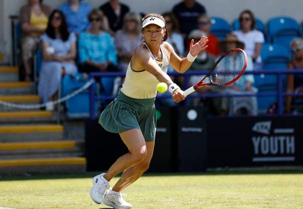 25th June 2024; Devonshire Park, Eastbourne, East Sussex, England: Rothesay International Eastbourne, Day 2, Yuriko Miyazaki (GBR) plays a backhand against Elise Mertens (BEL) womens singles  ActionPlus12660319 HongboxChen