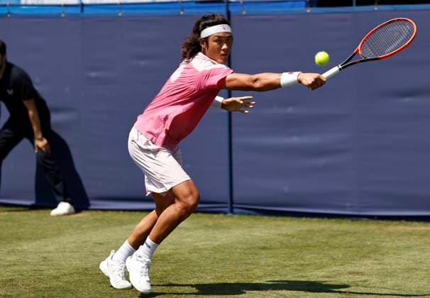 25th June 2024; Devonshire Park, Eastbourne, East Sussex, England: Rothesay International Eastbourne, Day 2; Zhizhen Zhang (CHN) plays a backhand against Miomir Kecmanovic (SRB) mens singles  ActionPlus12660380 HongboxChen