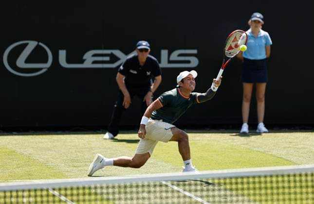 25th June 2024; Devonshire Park, Eastbourne, East Sussex, England: Rothesay International Eastbourne, Day 2; Yoshihito Nishioka (JPN) plays a forehand against Liam Broady (GBR) mens singles  ActionPlus12660371 HongboxChen